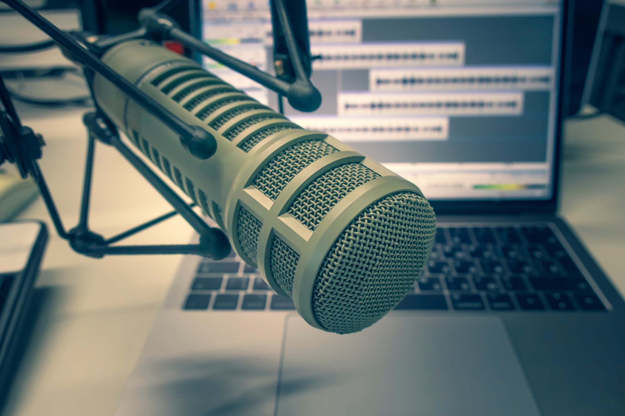 Studio microphone in front of an opened laptop