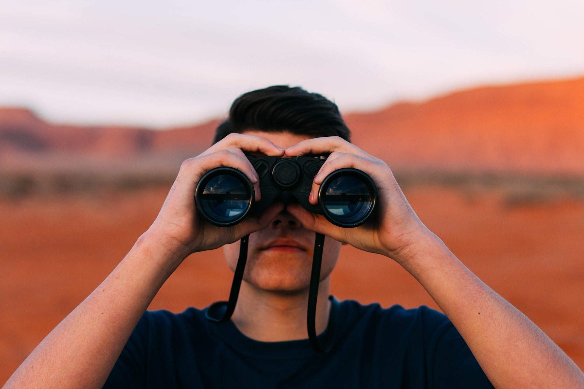 Person looking through binoculars.